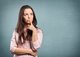 Woman standing in a thinking pose [Image by creator BillionPhotos.com from AdobeStock]